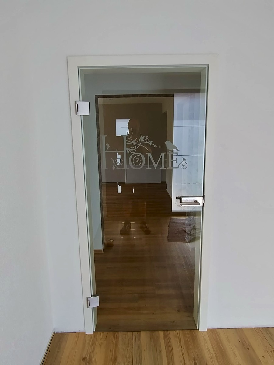 Ganzglas Innentür Motiv "Home" Fläche KLAR , Motiv MATTIERT aus 8mm ESG mit Edelstahl Ganzglastürbeschlag und Holzzarge in Weißlack RAL9010 Reinweiss